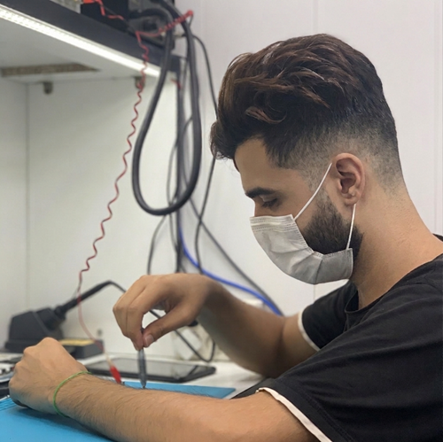 Amir Mohammad Shams working on electronics